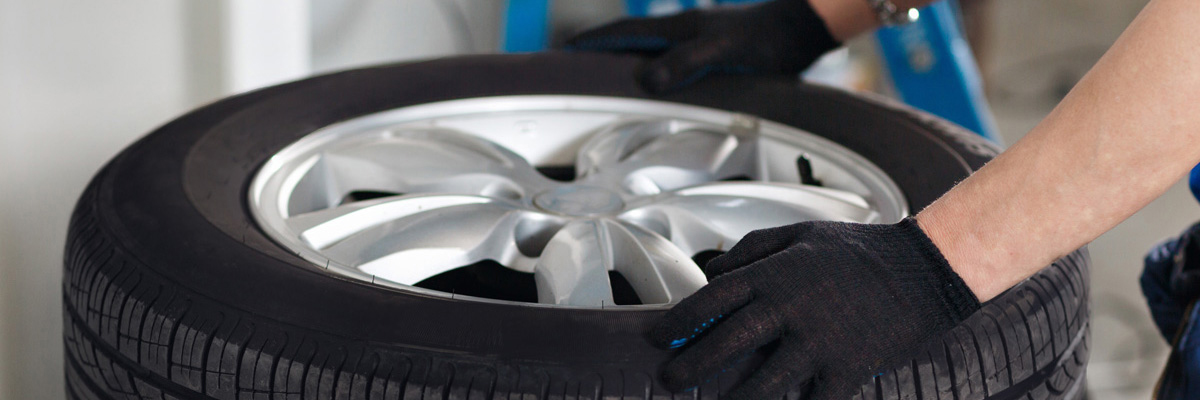 Mechanic fitting a tyre to a vehicle - Tyres Fenland